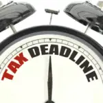 IMAGE OF A CLOCK TO DEPICT THE BUSINESS TAX RETURN DEADLINE FOR 2025